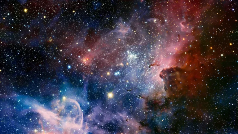 Vibrant colorful nebula filled with bright stars and cosmic dust clouds in deep space.