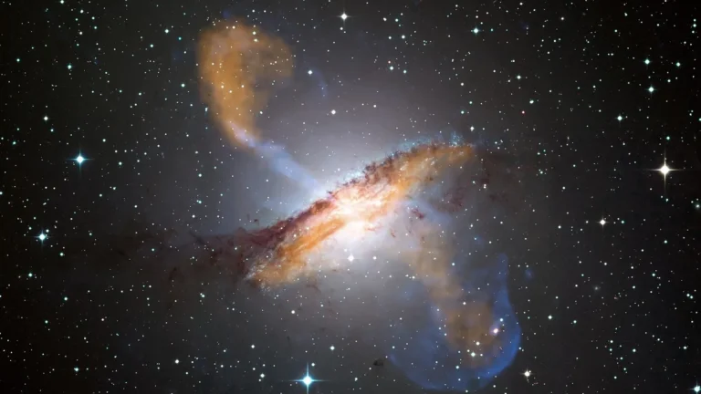 A bright galaxy showing a central dust lane and vibrant orange and blue jets shooting into starry space.