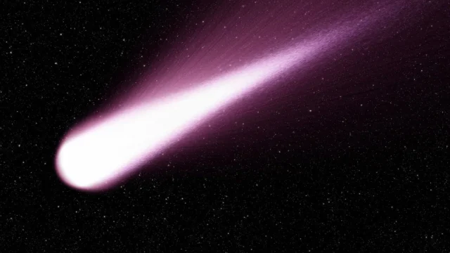 A bright comet with a glowing purple tail streaks across a star-filled dark space background.