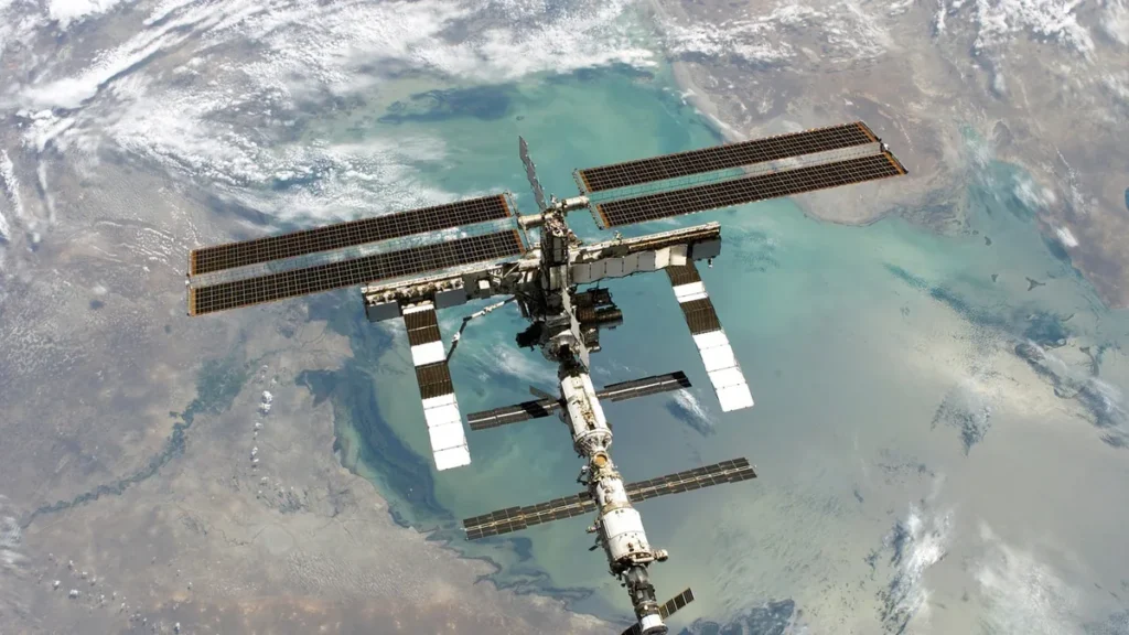 The International Space Station orbits Earth, showcasing its massive solar panel arrays.