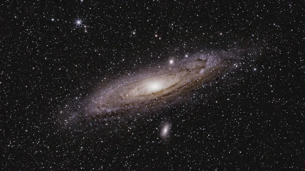 Andromeda Galaxy shines with a bright core and dusty spiral arms amidst a dense field of stars.