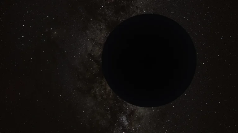 A large black circle obscuring a starry Milky Way background, representing a dark cosmic object.