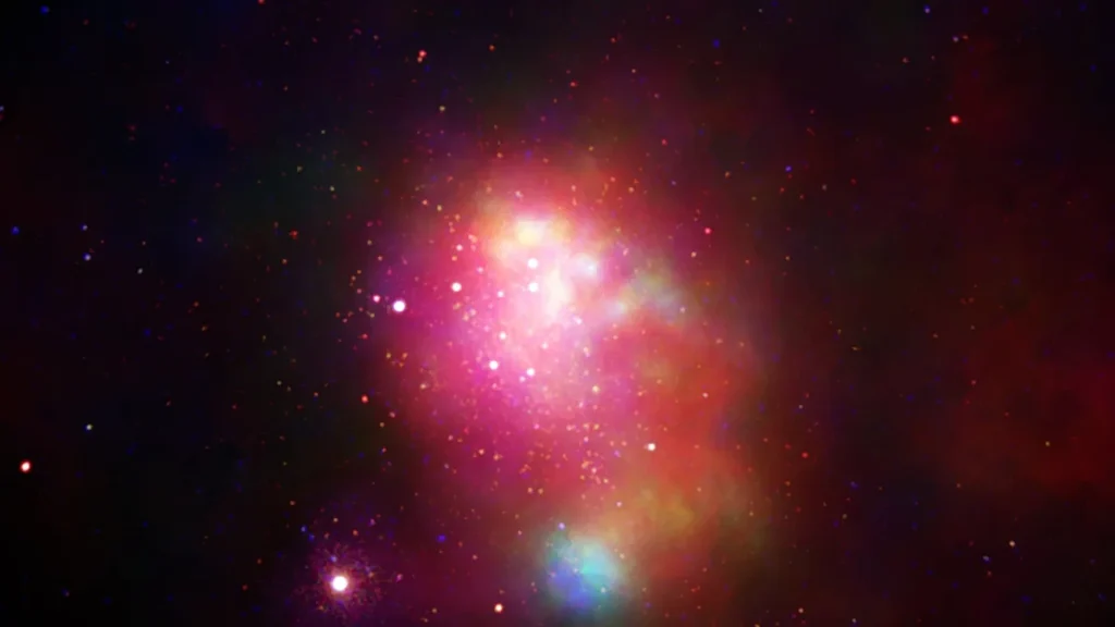 Vibrant pink and red cosmic nebula glowing brightly with scattered stars against a dark space background.