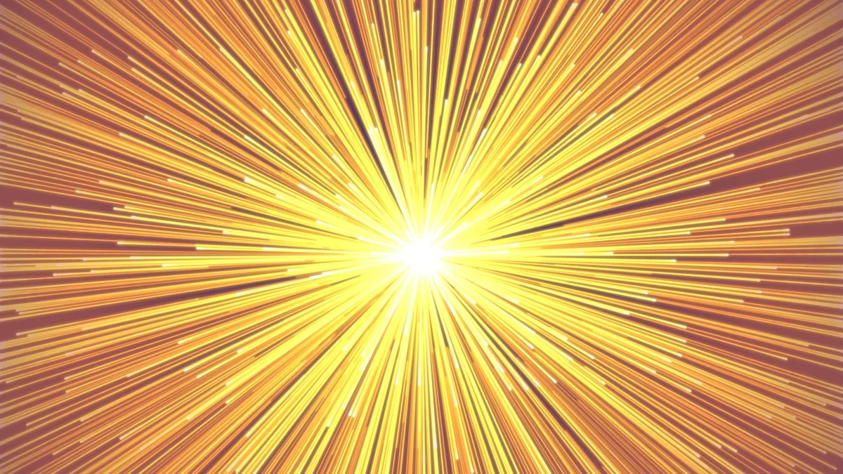 Bright yellow-orange cosmic burst radiating from a brilliant central white light source.