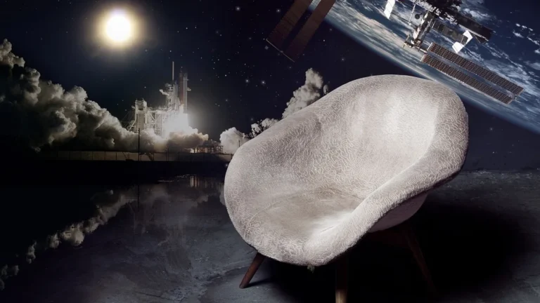 White armchair in the foreground with a space shuttle launch and the International Space Station in the background.