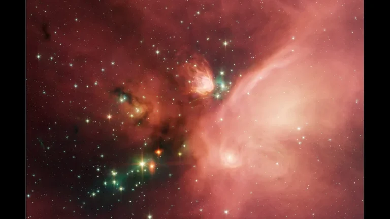 Vibrant pink and red nebula filled with bright stars and colorful cosmic dust clouds.