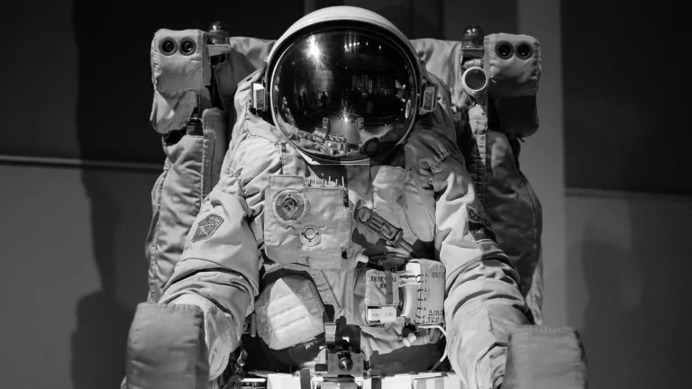 Black and white photo of a Russian spacesuit on display with a reflective visor.