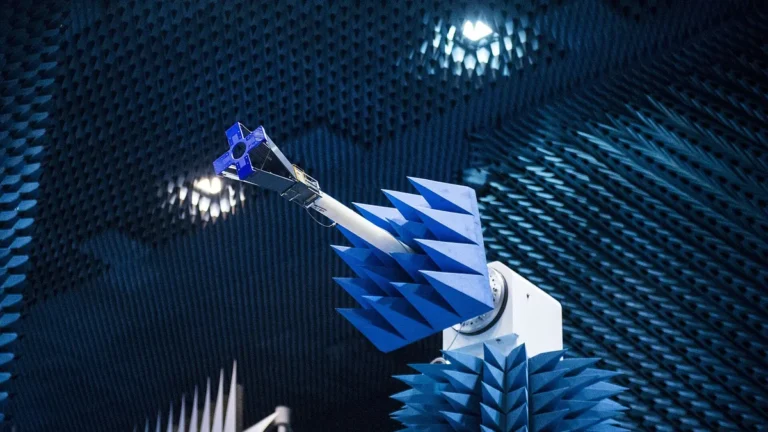 Blue space antenna tested in a dark, blue-padded anechoic chamber.