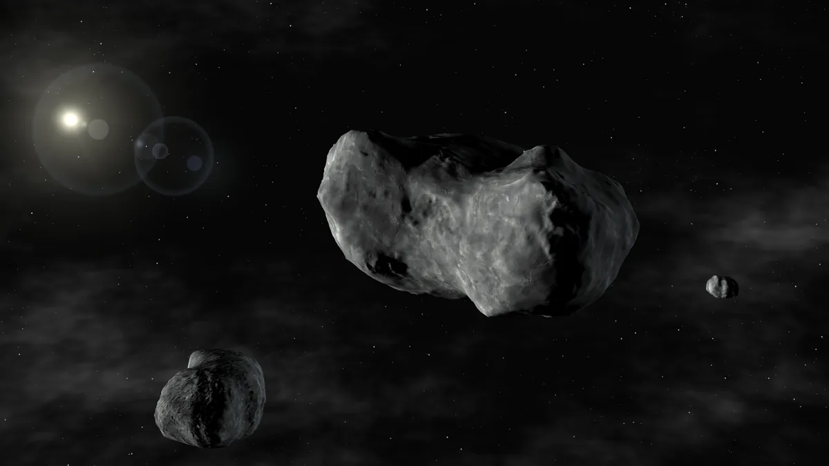 An artist's impression of a contact-binary asteroid system with multiple rocky bodies under a bright star in dark space.