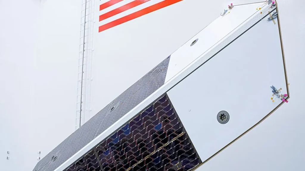 The integrated sunshade and solar array for NASA's NEO Surveyor, featuring dark solar cells and white panels.