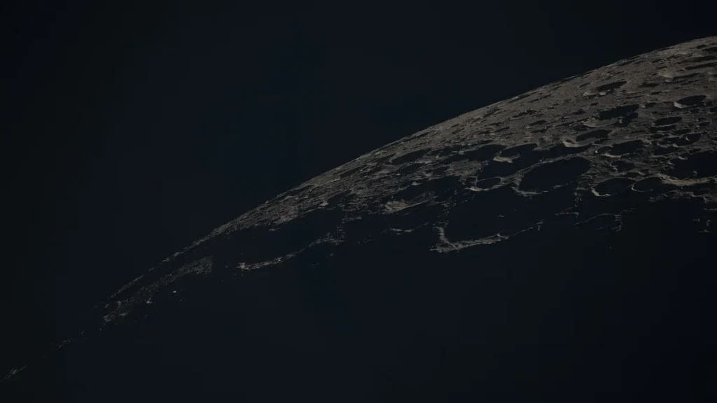 Cratered lunar surface partially illuminated against the dark void of space.