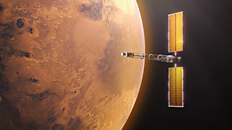 A spacecraft with large golden solar arrays orbits the orange, cratered surface of Mars.