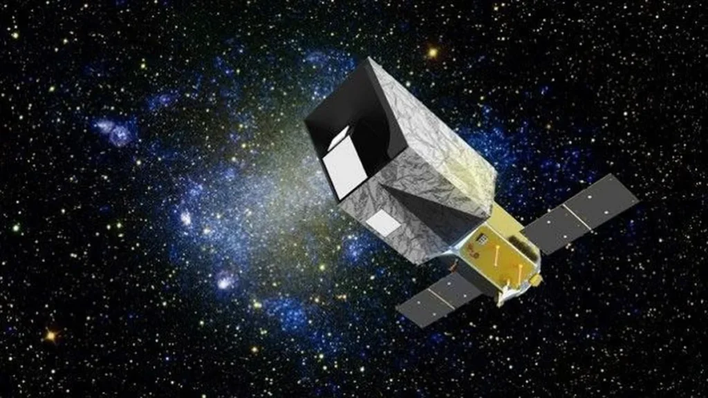 Concept art of a box-shaped space telescope with solar panels, set against a starry sky and blue nebula.