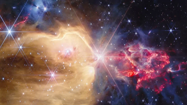 Vibrant cosmic nebula with brilliant stars and swirling clouds of colorful gas and dust.