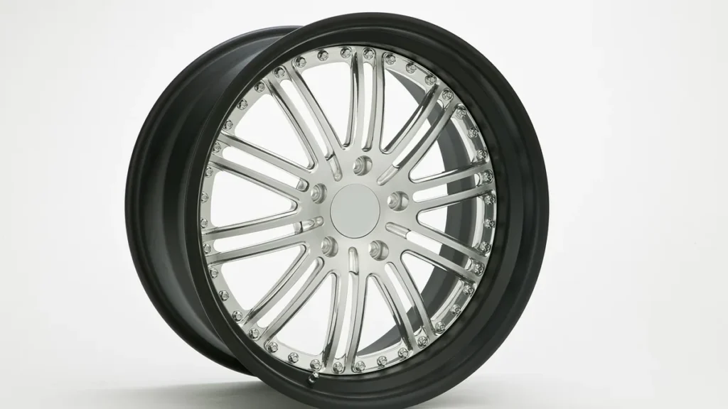 Polished silver multi-spoke car wheel with a black outer lip on a white background.