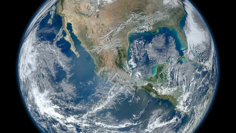 View of Earth showing North America, the Pacific Ocean, and swirling white cloud formations.