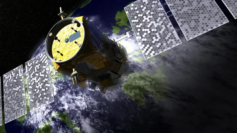 A high-tech satellite with hexagonal solar panels orbits a cloud-covered Earth in this artist's rendering.