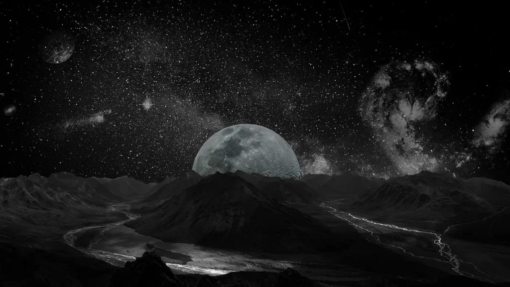 Black-and-white view of a giant moon rising over a mountainous landscape under a starry sky.