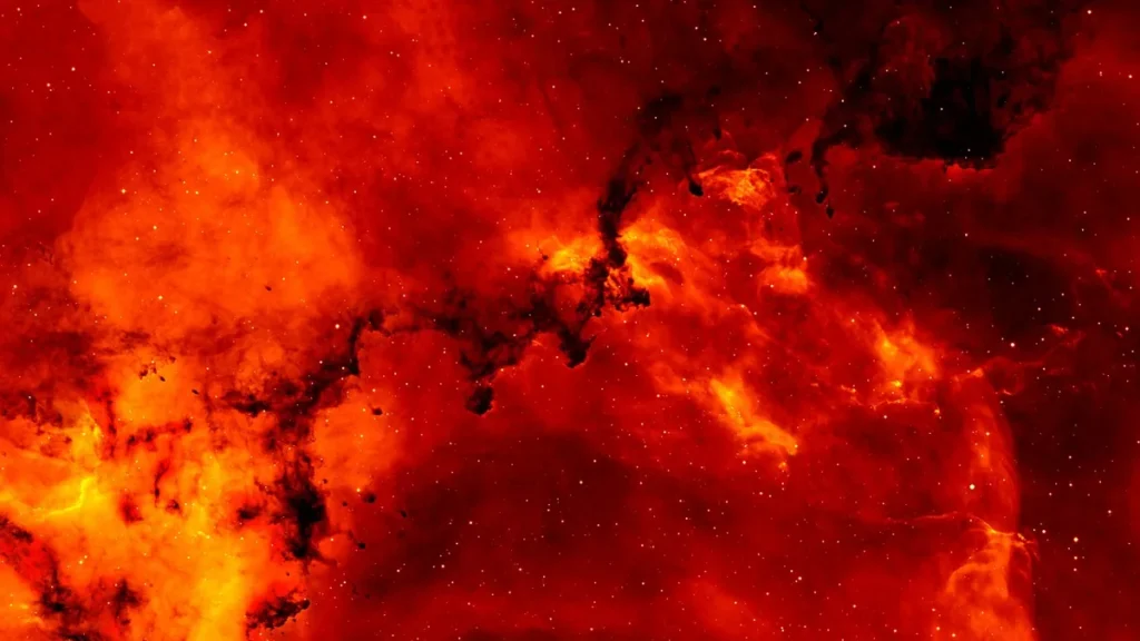 A vibrant red and orange nebula filled with stars and dark cosmic dust lanes.